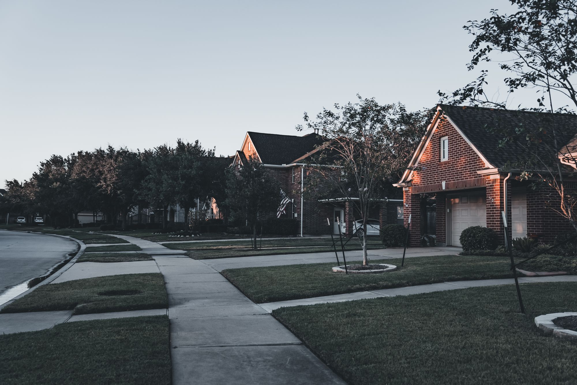 Brick houses on a residential street at dusk
